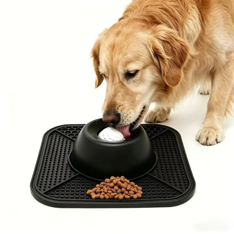 Dog using the black interactive lick tray with raised rolling-ball center